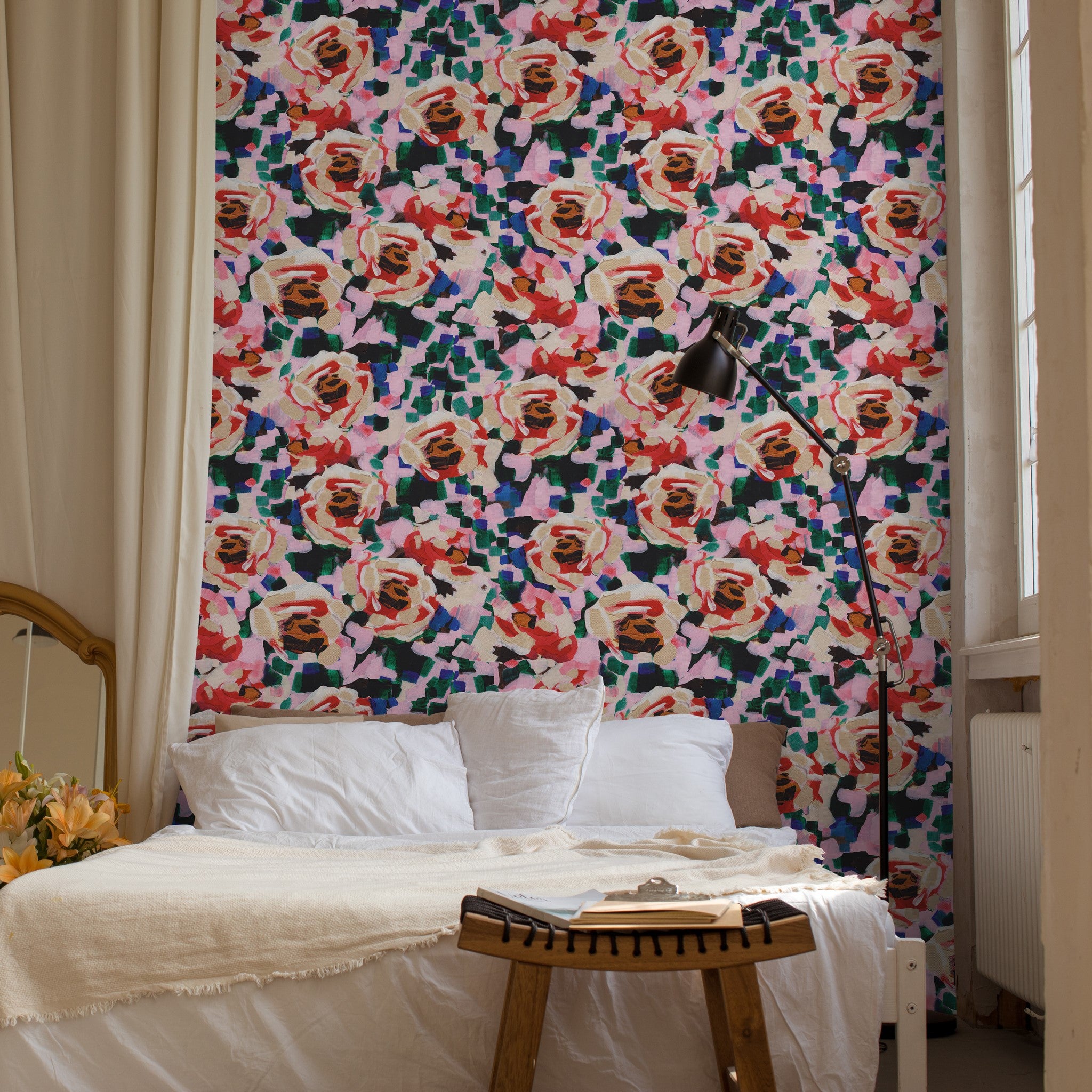 "Rosaleda Wallpaper by Wall Blush featured in a cozy bedroom setting, highlighting the vibrant floral design."