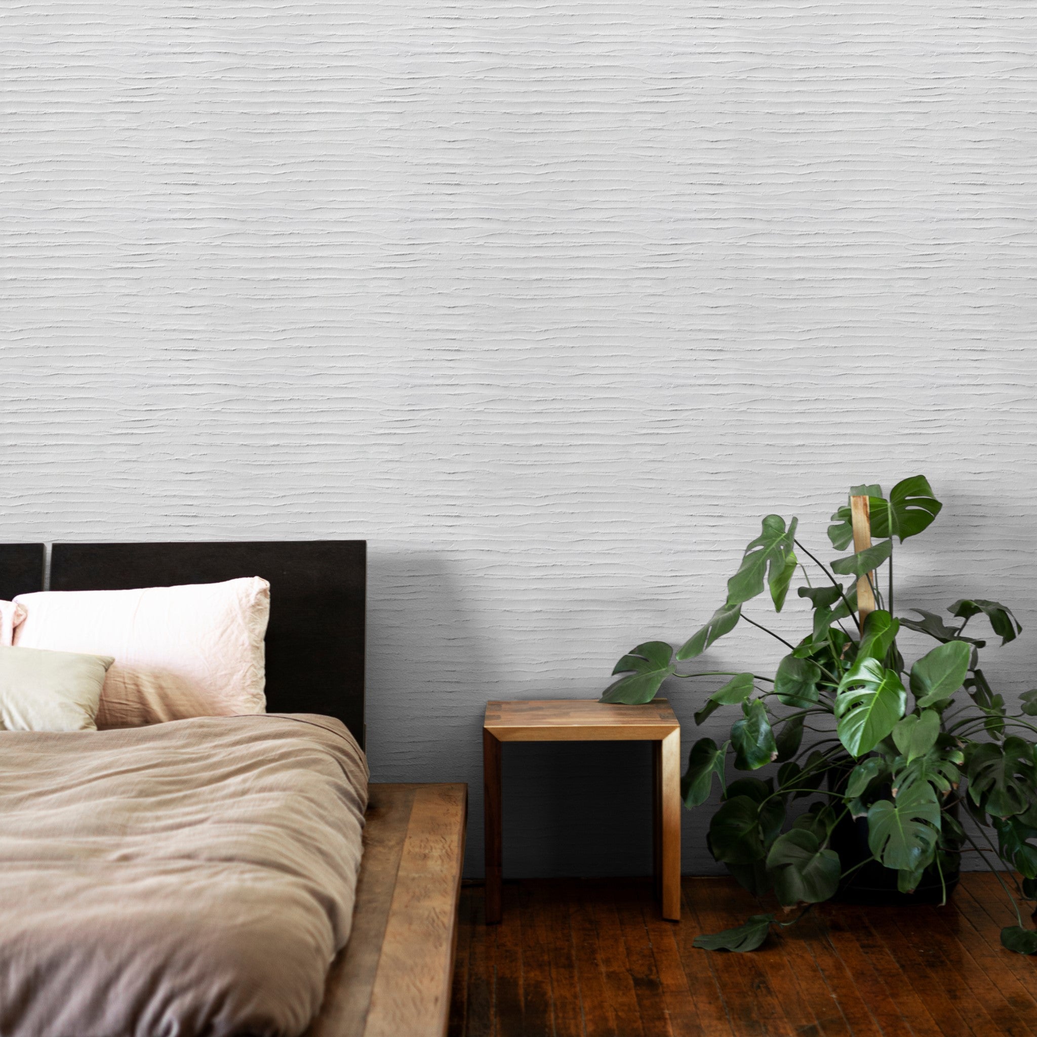 "Plaster Perfect Wallpaper by Wall Blush in serene bedroom setting, highlighting the textured wall focus."