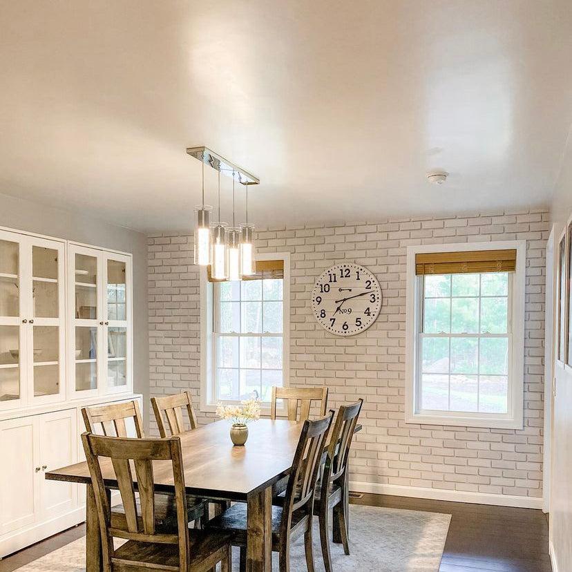 Dining room featuring Wall Blush’s Bella Brick (White) Wallpaper, creating a cozy and stylish atmosphere.