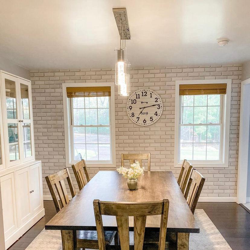 Bella Brick (White) Wallpaper by Wall Blush in a dining room setting, accentuating the cozy and modern space.