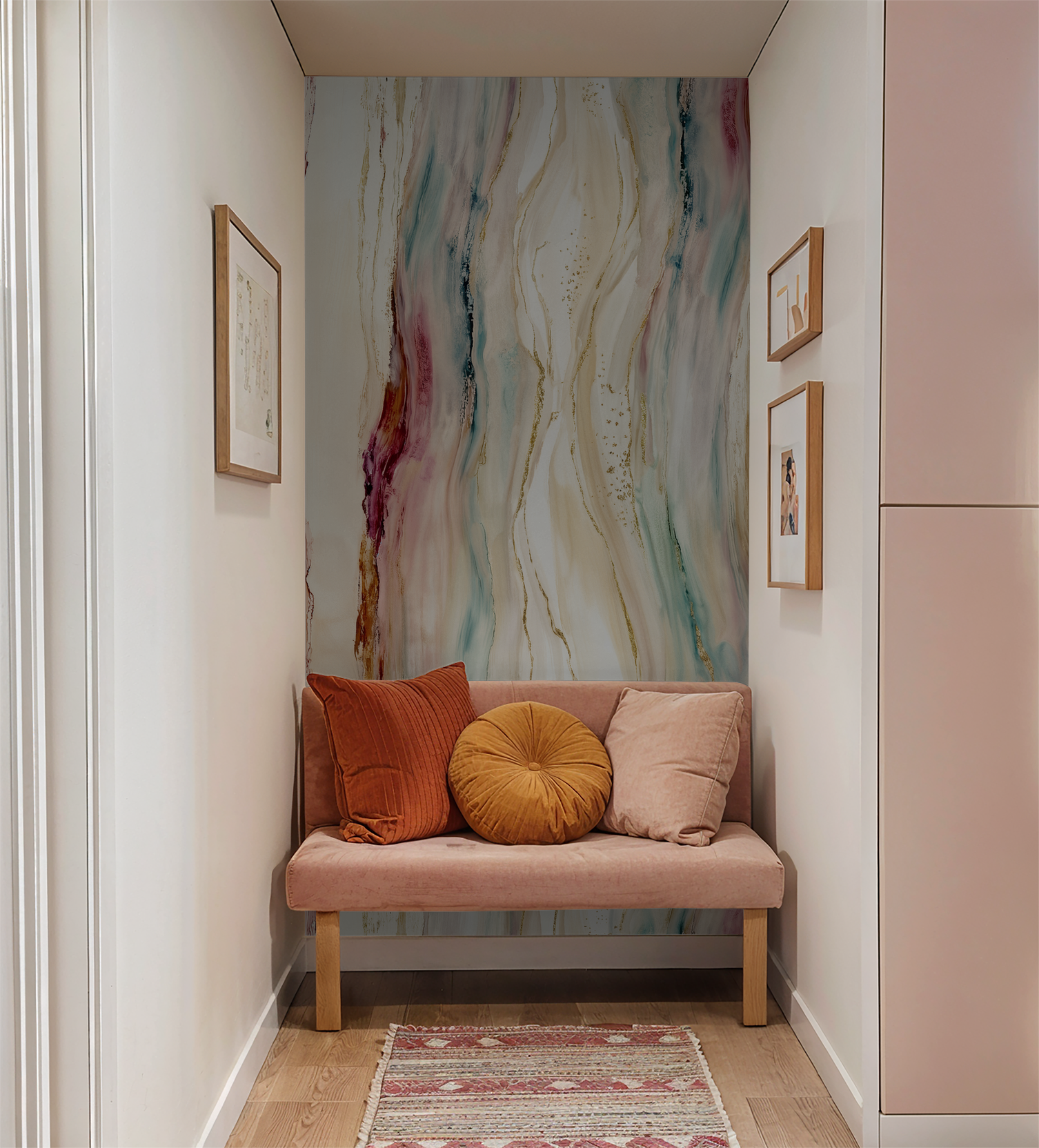 Abstract flowing wallpaper with gold accents in cozy nook with pink sofa and cushions.