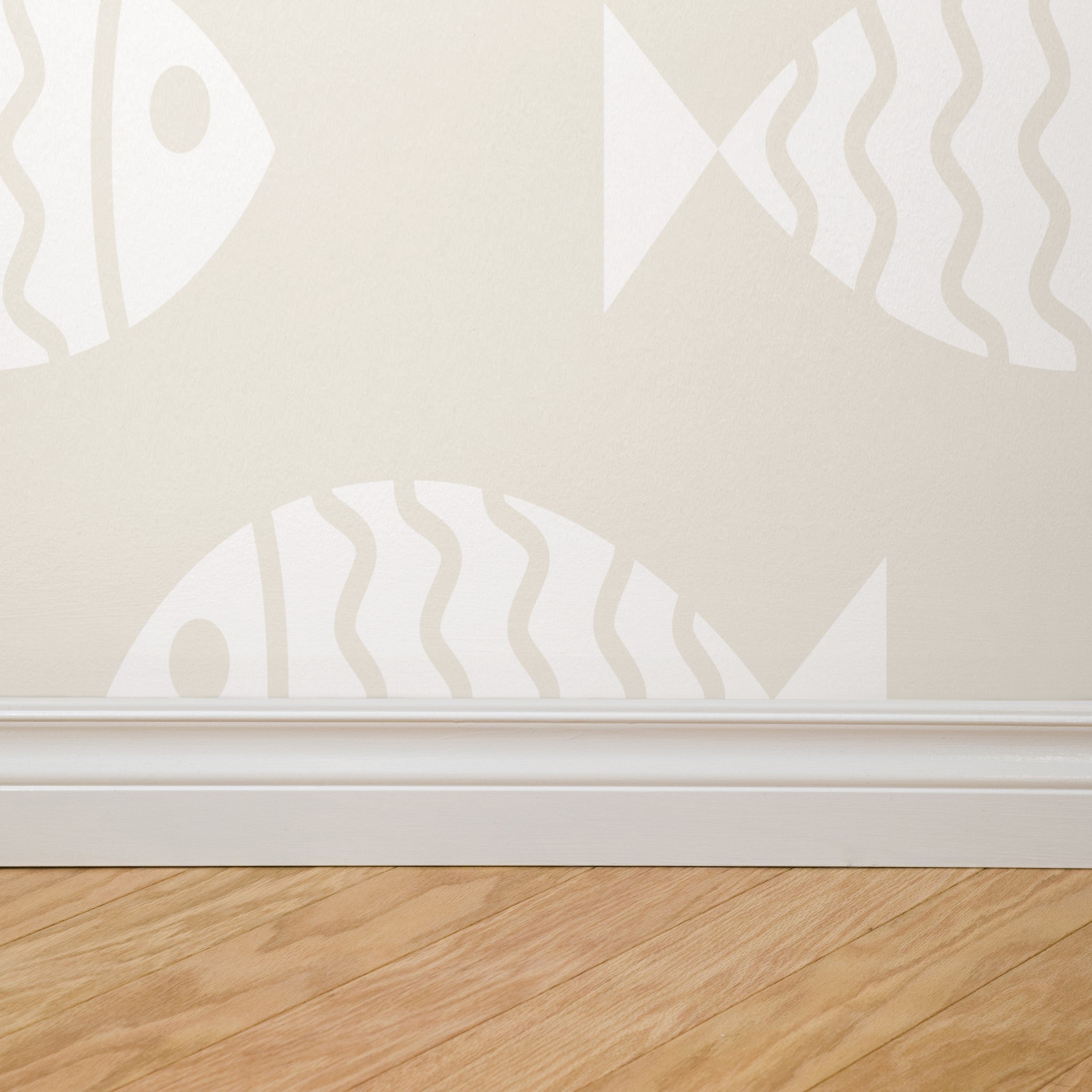 "Wall Blush's Keep Swimming Wallpaper installed on bedroom wall, showcasing subtle fish patterns with focus on design."