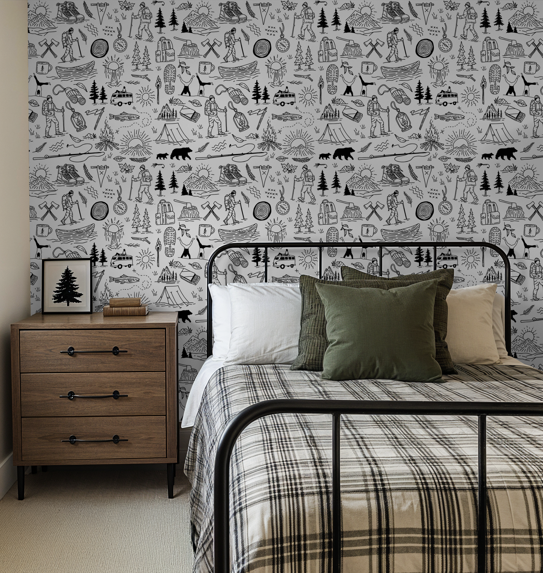 Black and white adventure-themed wallpaper in a rustic bedroom setting.