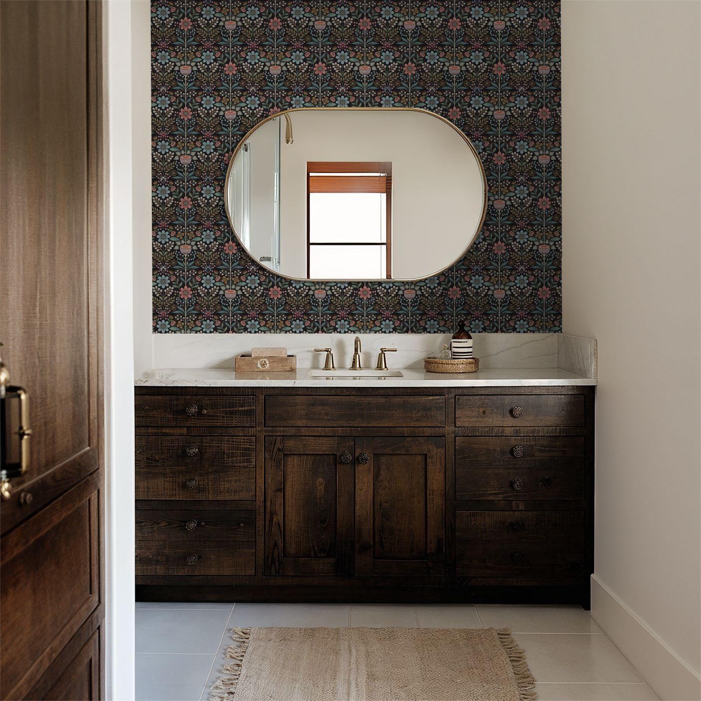 Bloomshire floral wallpaper in bathroom with wooden vanity and oval mirror.