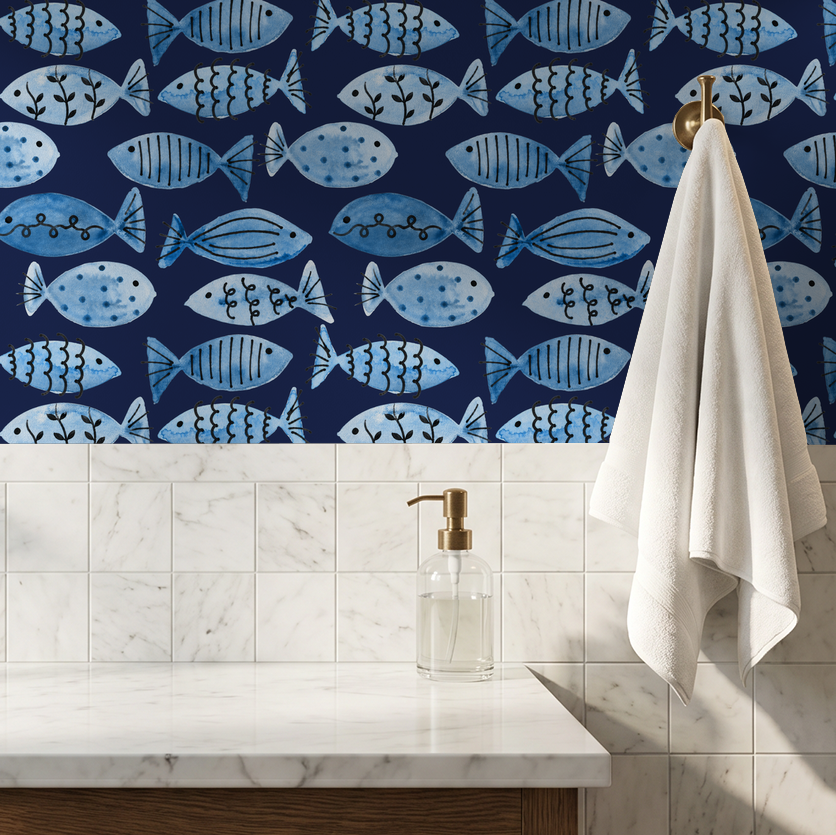 Blue fish patterned wallpaper with whimsical motifs on navy background in bathroom setting.