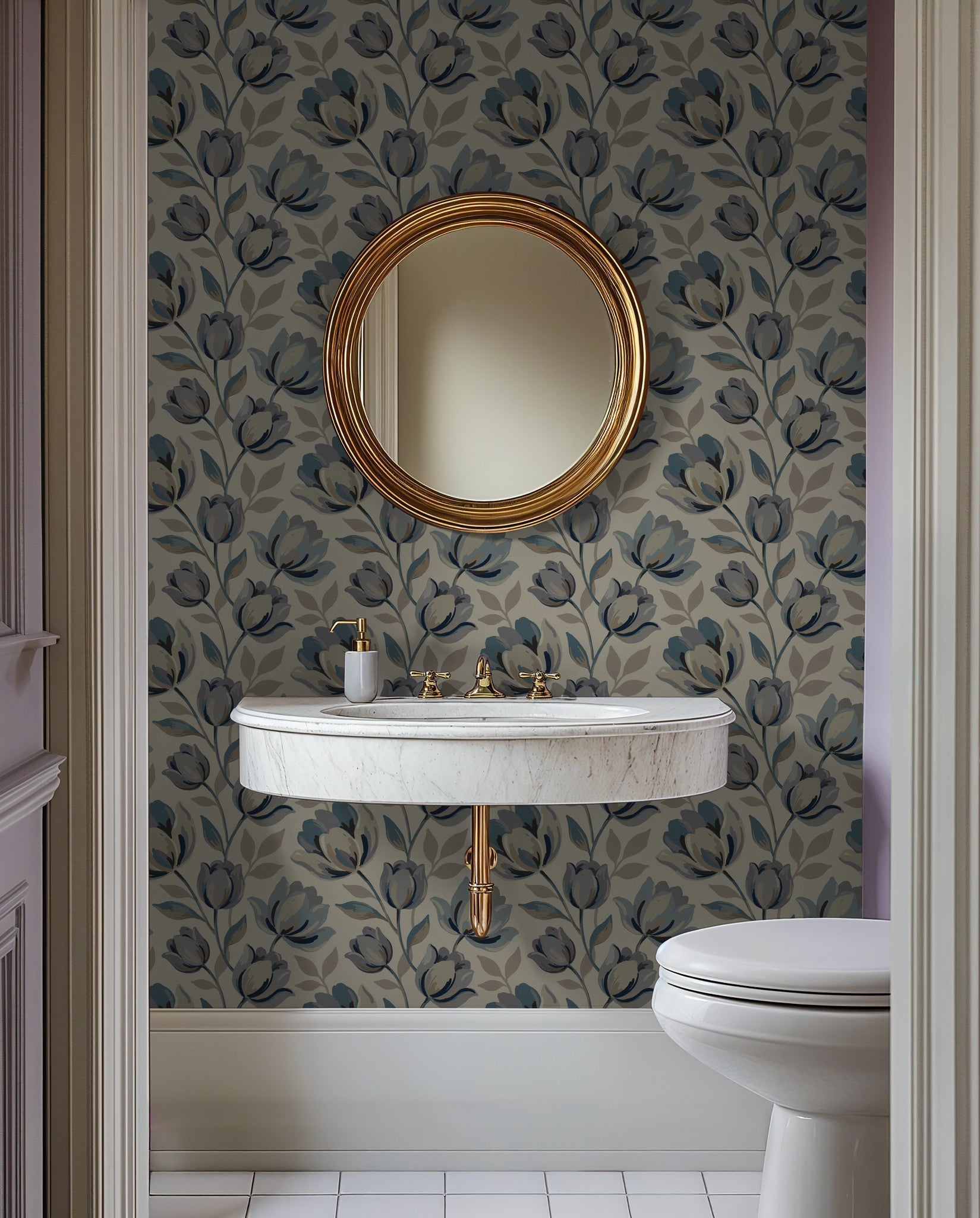Elegant blue floral wallpaper in bathroom with gold mirror and marble sink.