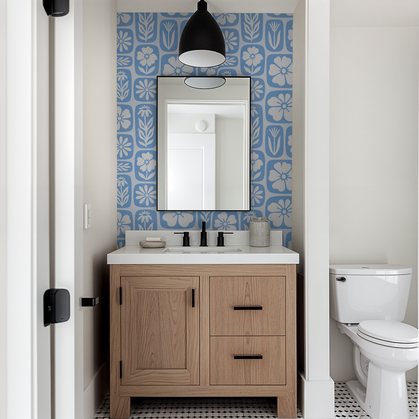 Blue floral wallpaper with white silhouettes in a modern bathroom setting.
