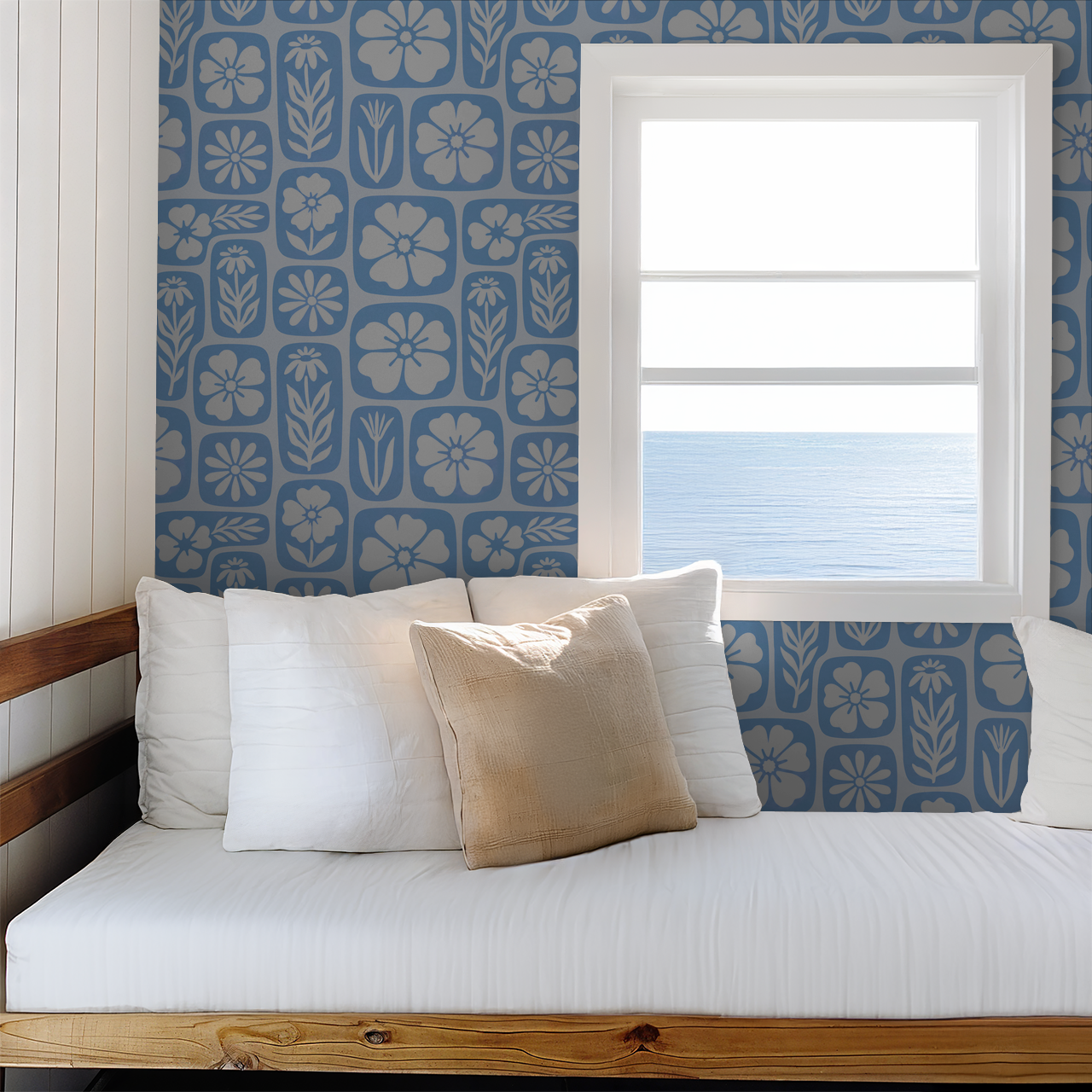 Blue floral wallpaper with white blossoms in a cozy room with ocean view.
