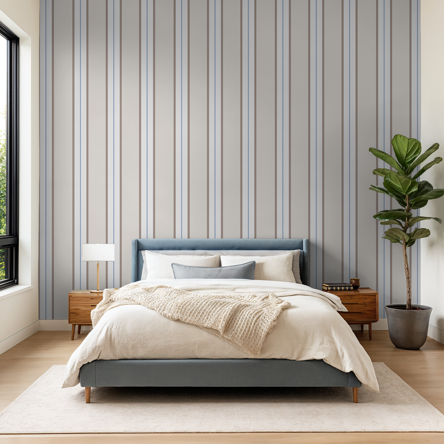 Modern bedroom with blue striped wallpaper, neutral tones, and cozy decor.