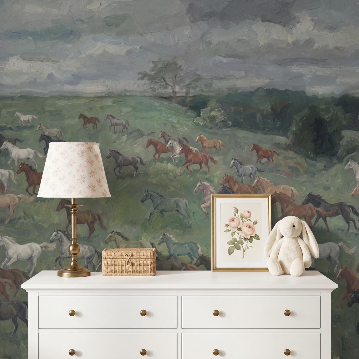 Bridlewood wallpaper with horses in a meadow behind a white dresser with lamp and decor.