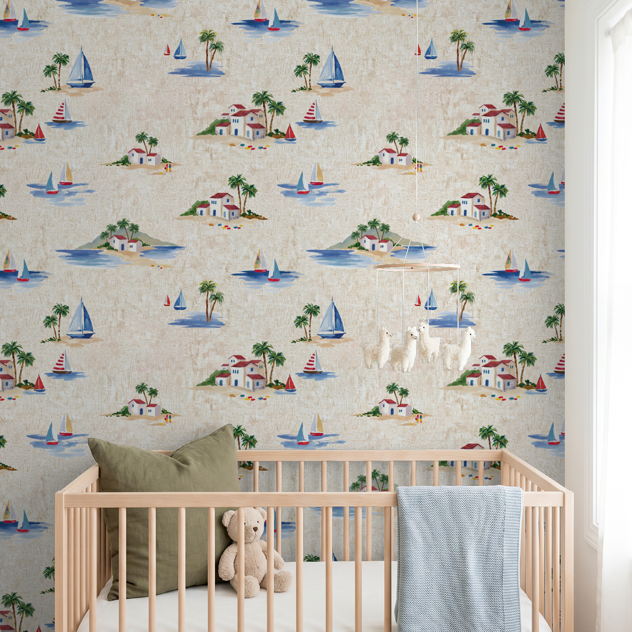Coastal sailboat wallpaper in nursery with crib and teddy bear.