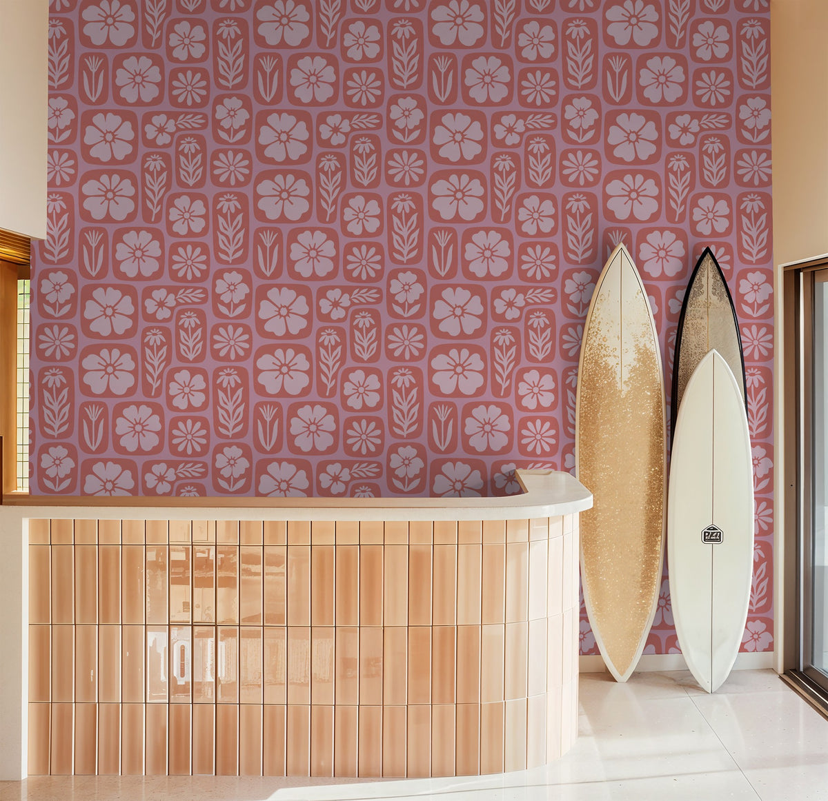 Coral floral wallpaper with surfboards in modern room setting.