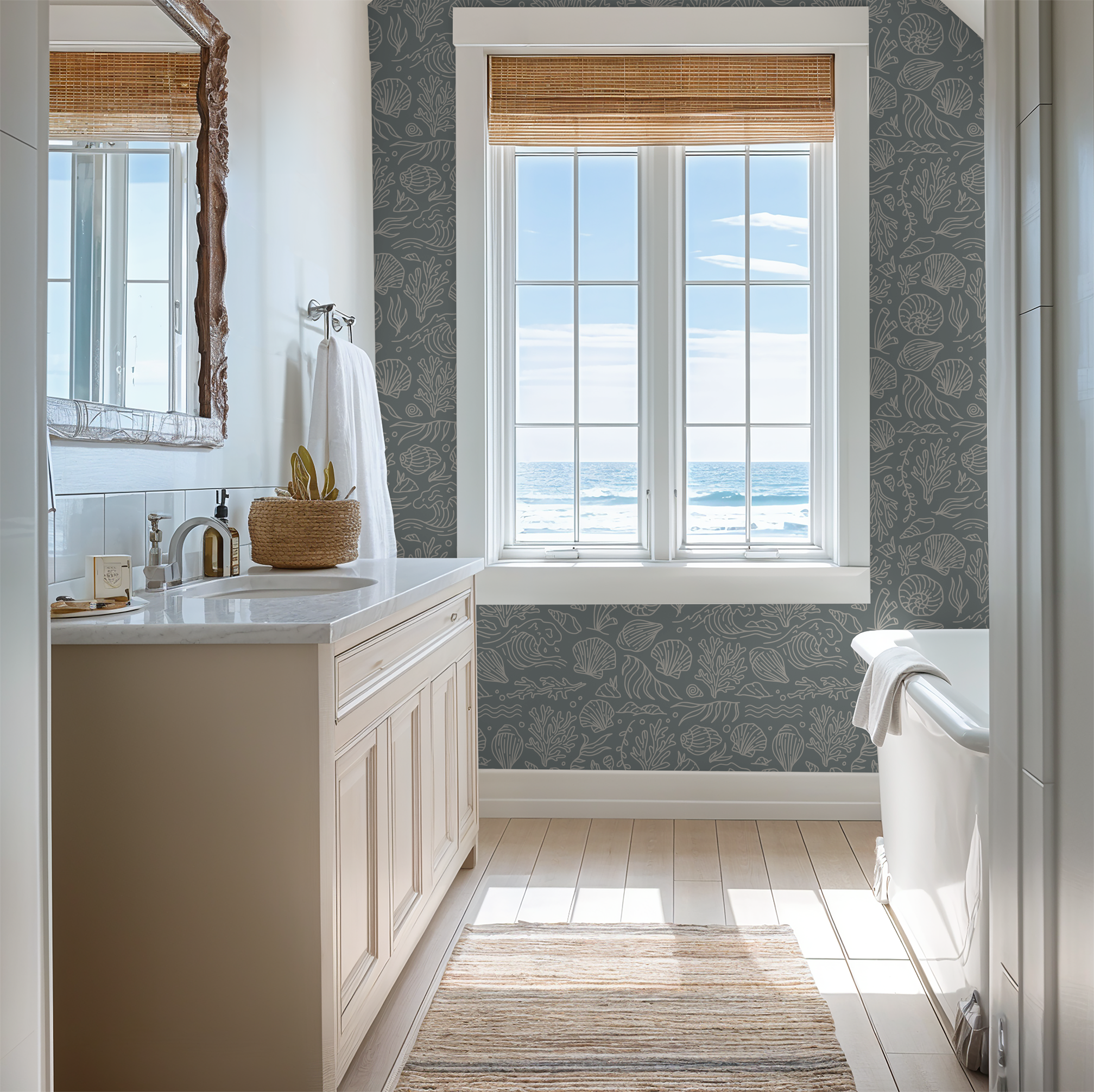 Coastal bathroom with dusty blue seashell wallpaper and ocean view.