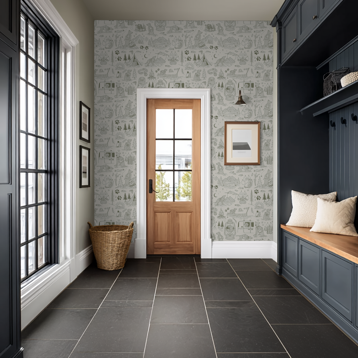 Green and cream wilderness-themed wallpaper in a modern entryway with black tiles and wooden accents.