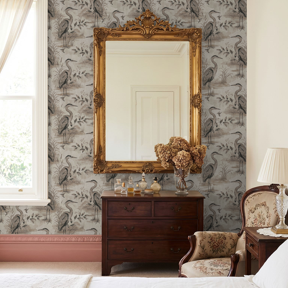 Heron Lake wallpaper with herons and foliage in taupe and sepia in vintage bedroom.