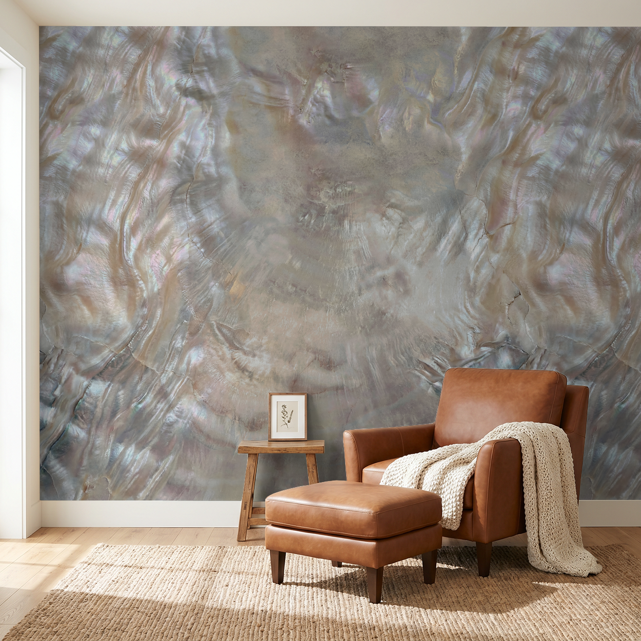 Iridescent textured wallpaper in a modern living room with leather chair and ottoman.