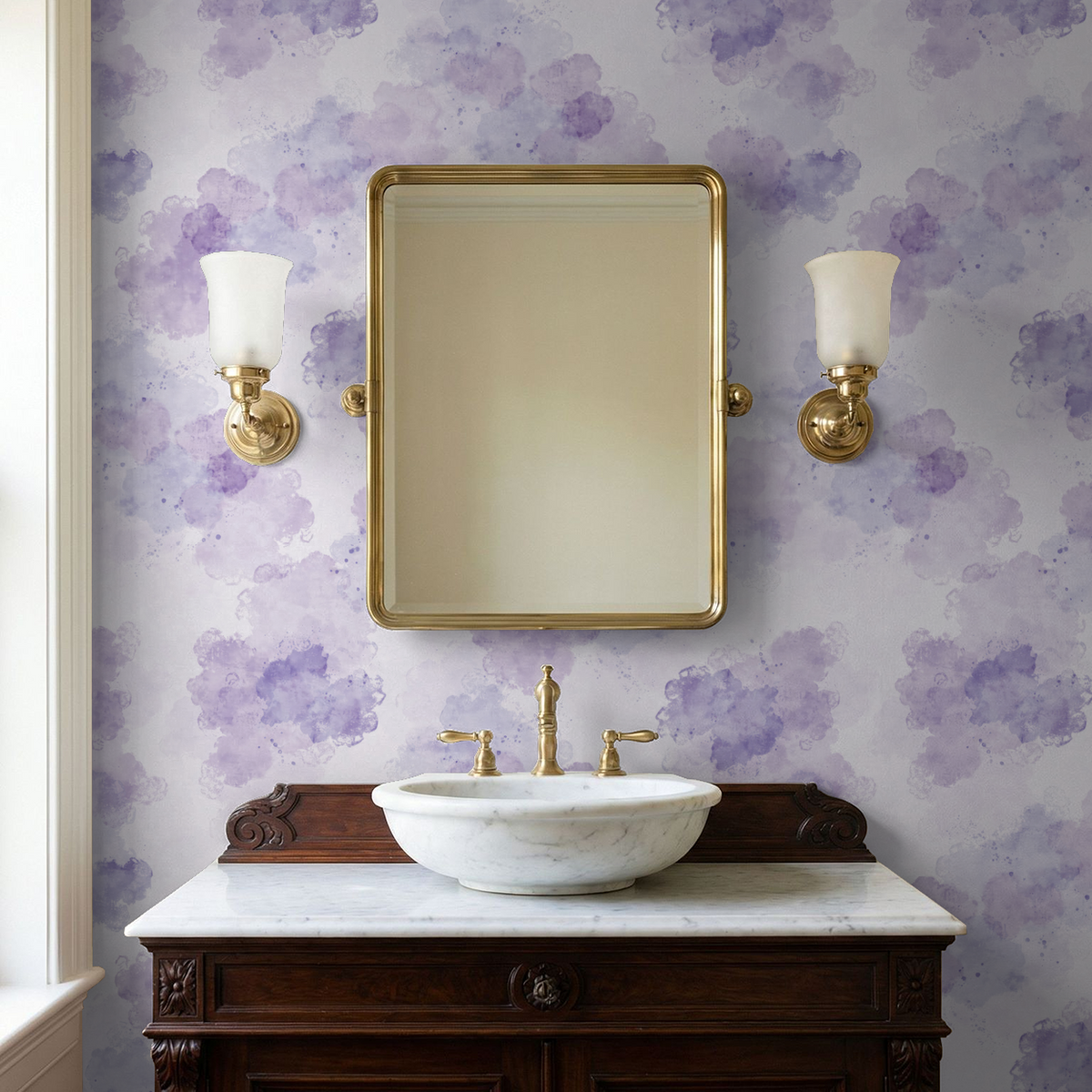 Lavender watercolor wallpaper in bathroom with gold fixtures and marble sink.