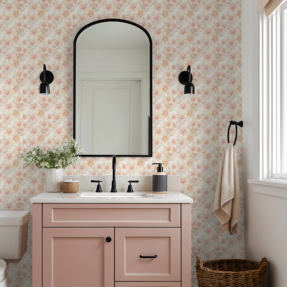 Bathroom with Mabel Floral wallpaper in blush and cream, pink vanity, and black accents.