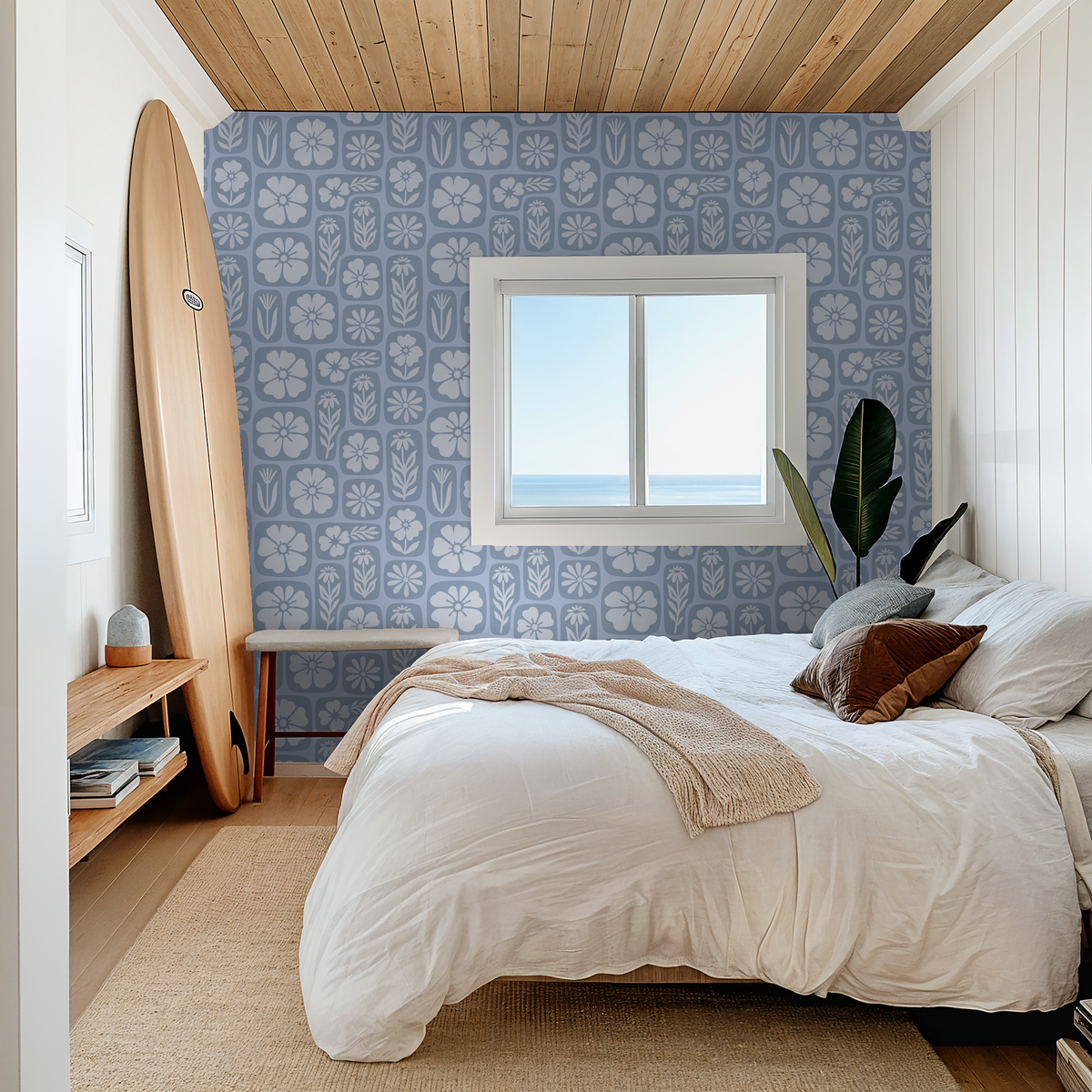 Mono blue floral wallpaper in serene bedroom with surfboard decor