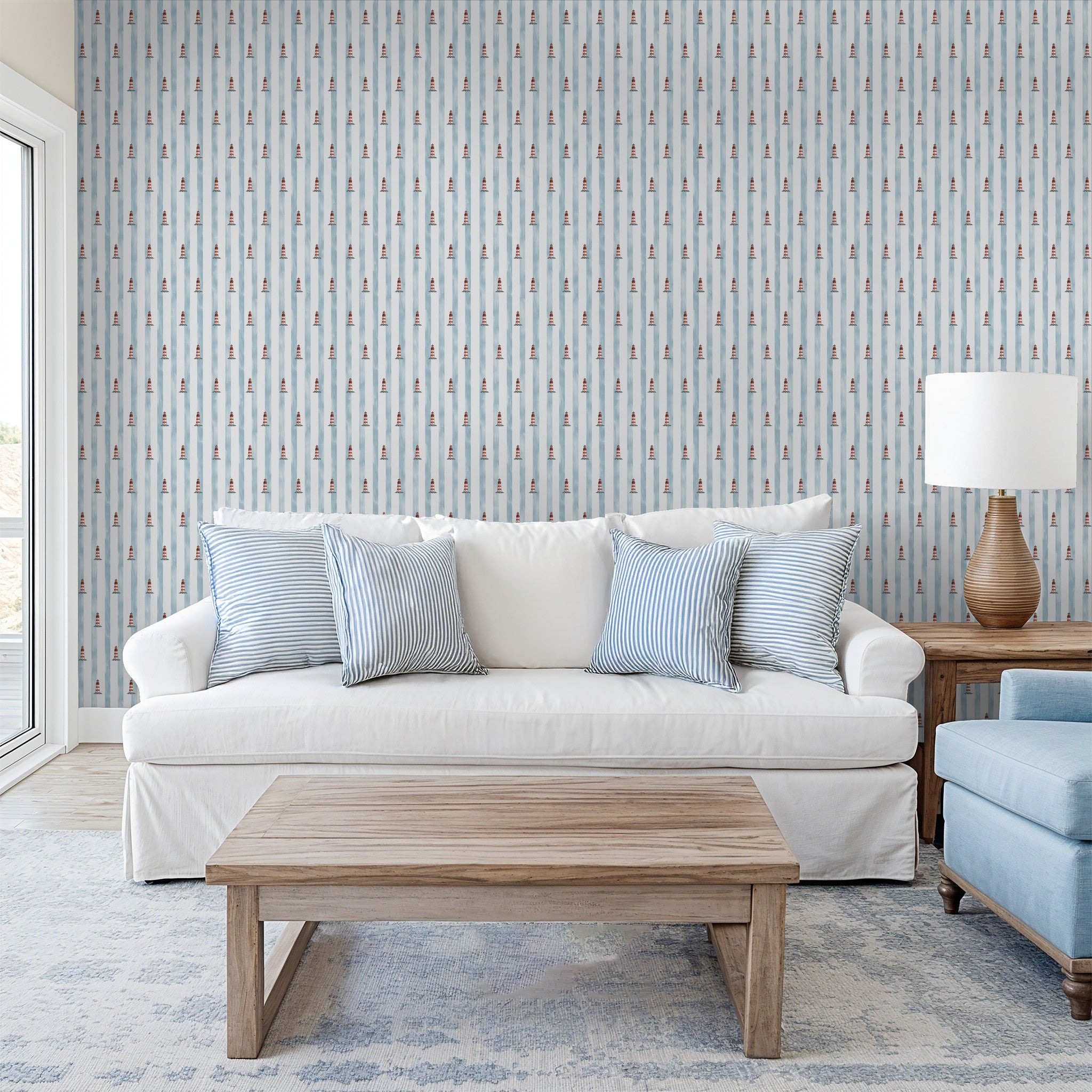 Nautical wallpaper with red lighthouses and blue stripes in cozy living room.