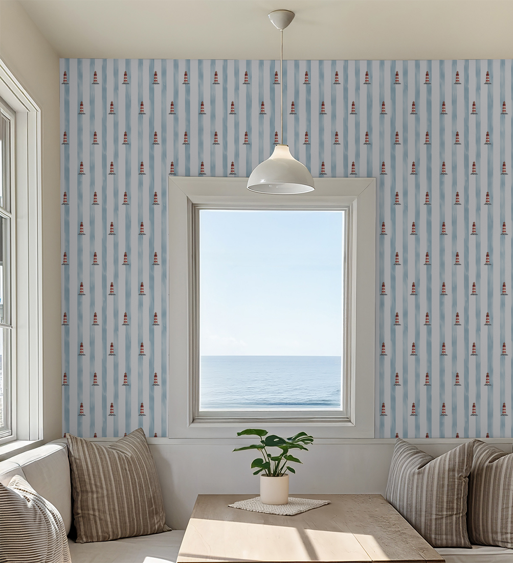 Nautical wallpaper with red lighthouses and blue stripes in a coastal dining room.