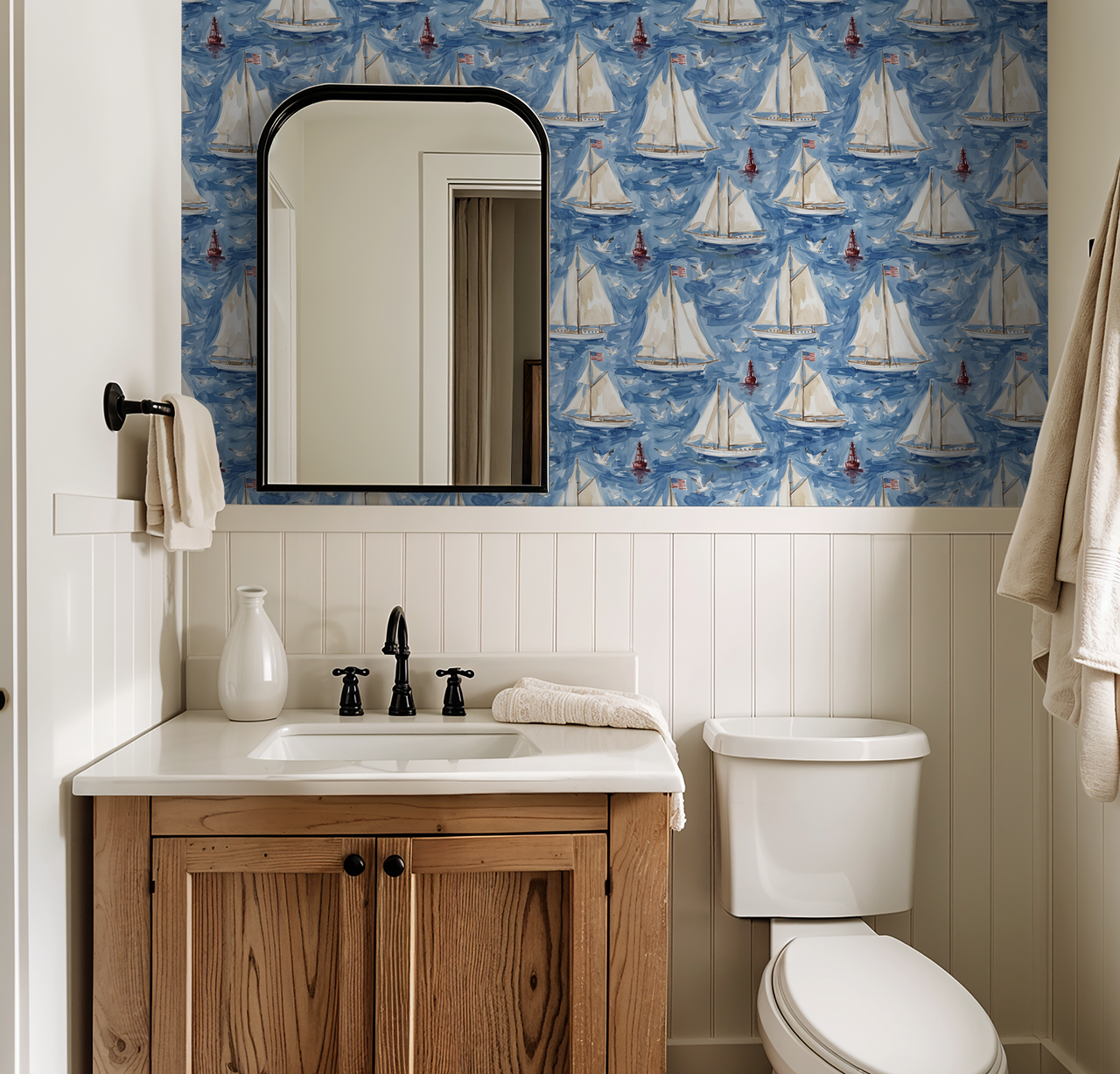 Nautical sailboat wallpaper in blue and white in a coastal bathroom.