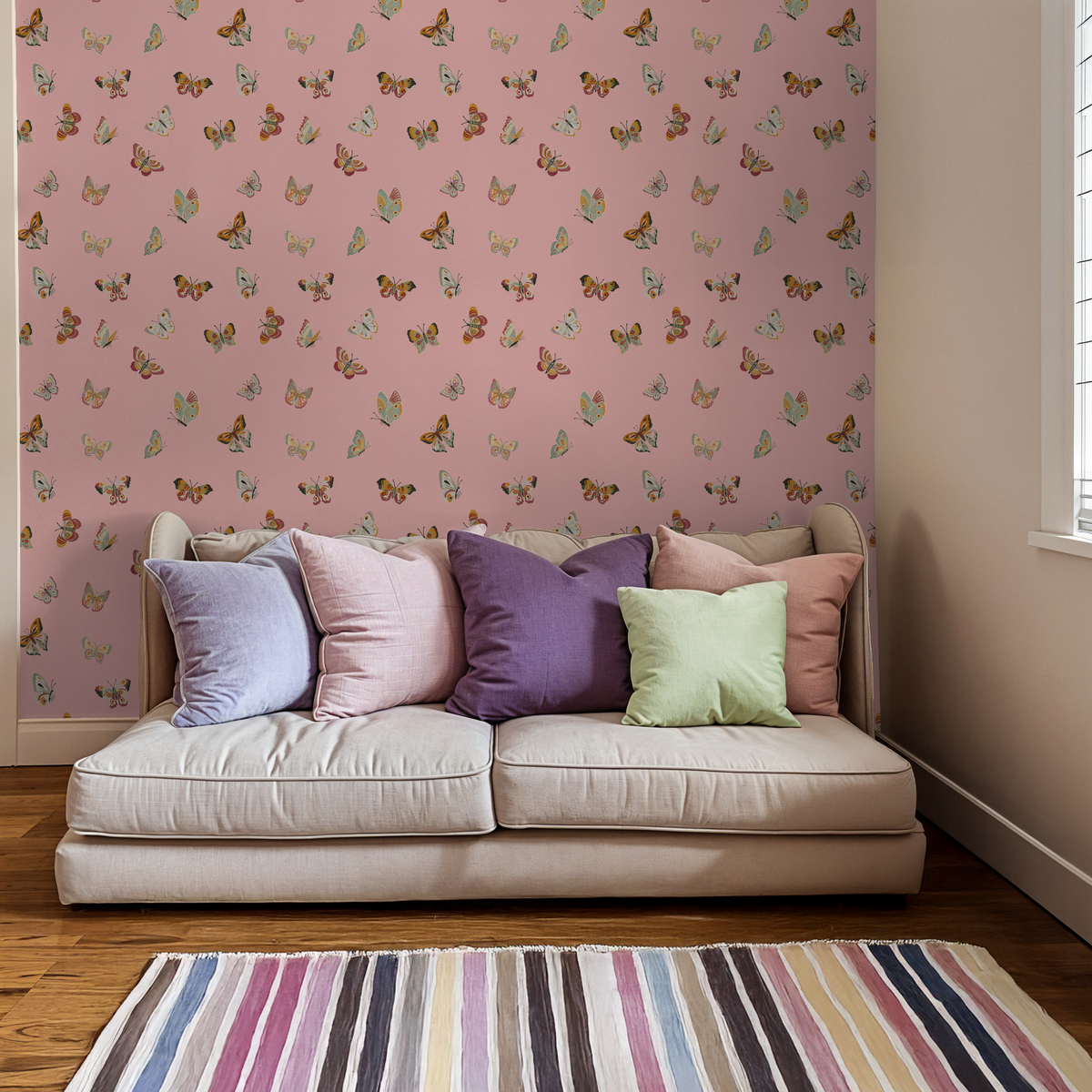 Pink butterfly wallpaper in cozy living room with colorful pillows and striped rug.