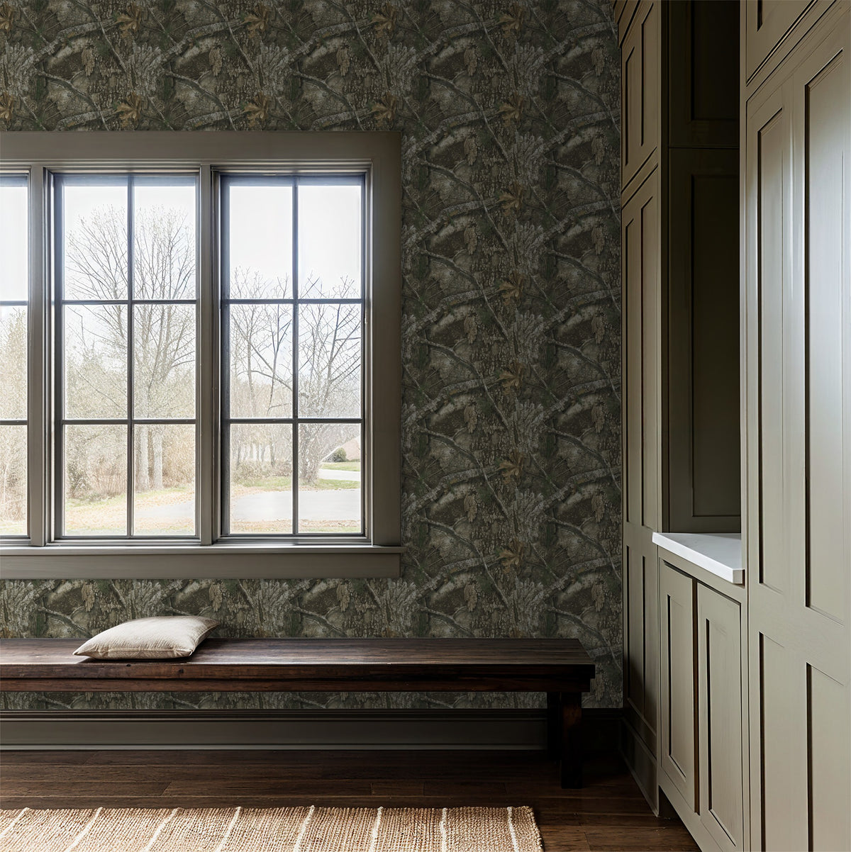 Realtree APX wallpaper with bark and leaf pattern in rustic room with window.