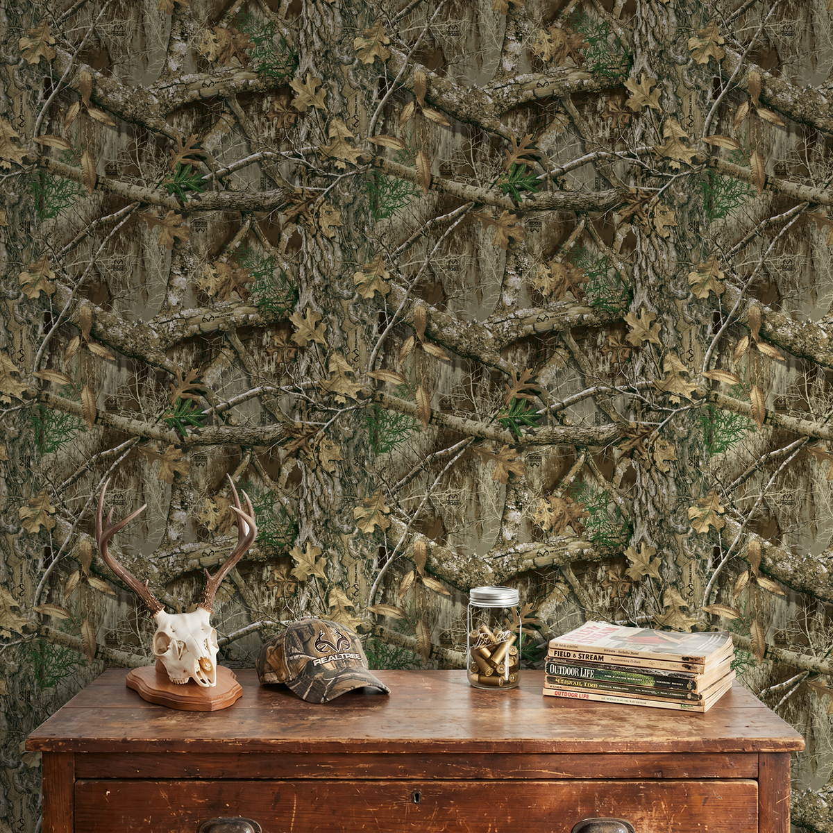 Realtree Edge wallpaper with branches and leaves in earthy tones behind rustic table.