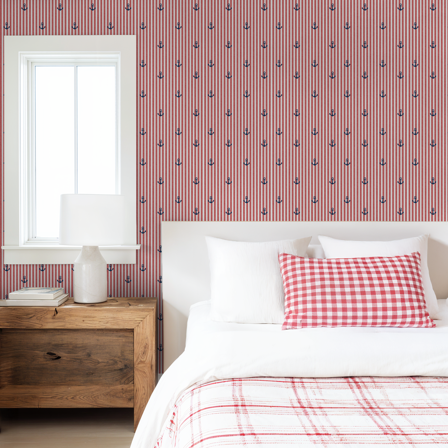 Red and white striped wallpaper with blue anchors in a cozy bedroom setting.