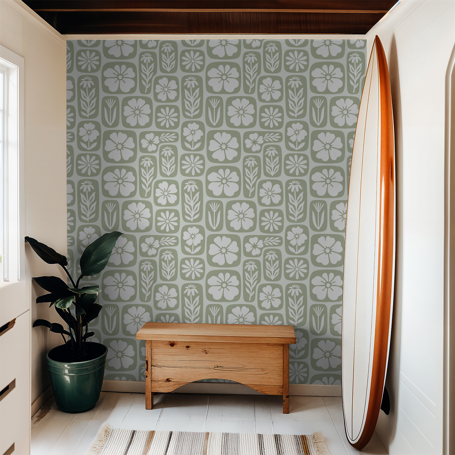 Sage green and white floral wallpaper in a cozy room with wooden bench and surfboard.