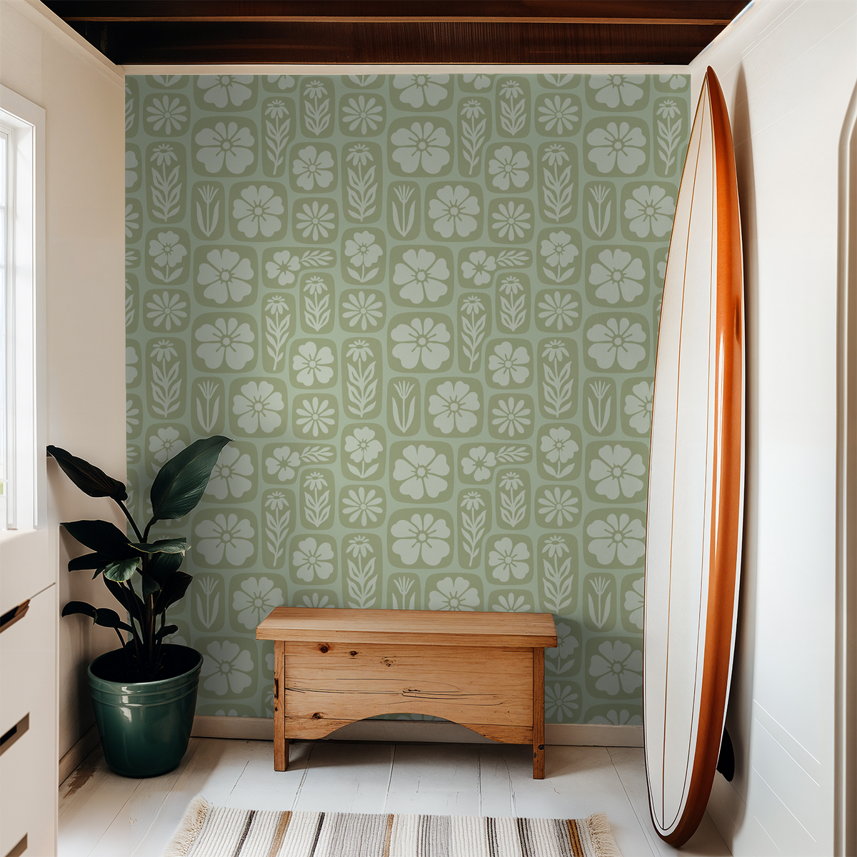 Sage green floral wallpaper in a modern room with surfboard and plant