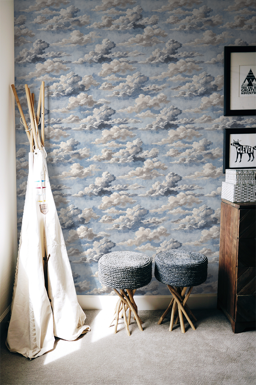 Skyphoria cloud wallpaper in soft blues and grays in a cozy room with stools.