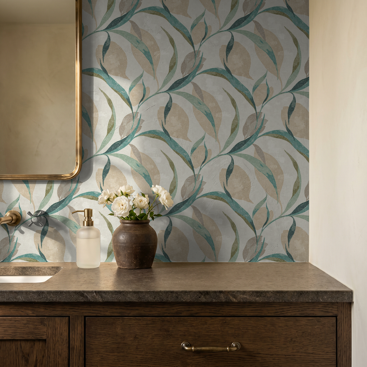 Teal and beige leaf pattern wallpaper in bathroom with wooden vanity.