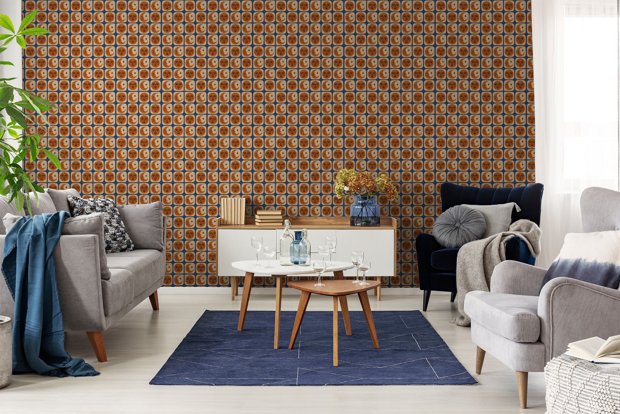 Terracotta face and cream moon wallpaper in modern living room with gray sofas and blue rug.