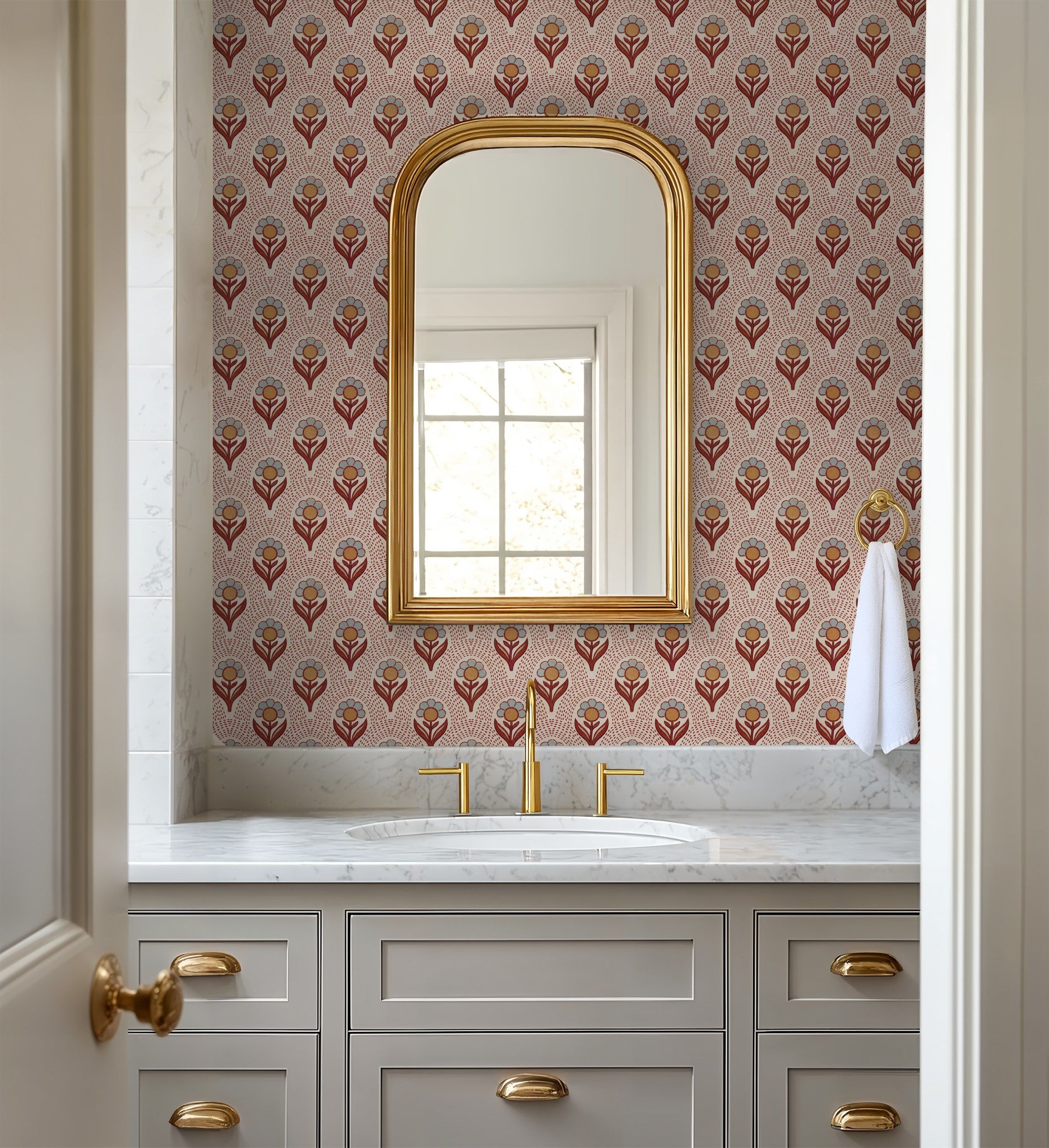 Vintage floral wallpaper with rust and ochre tones in elegant bathroom setting.
