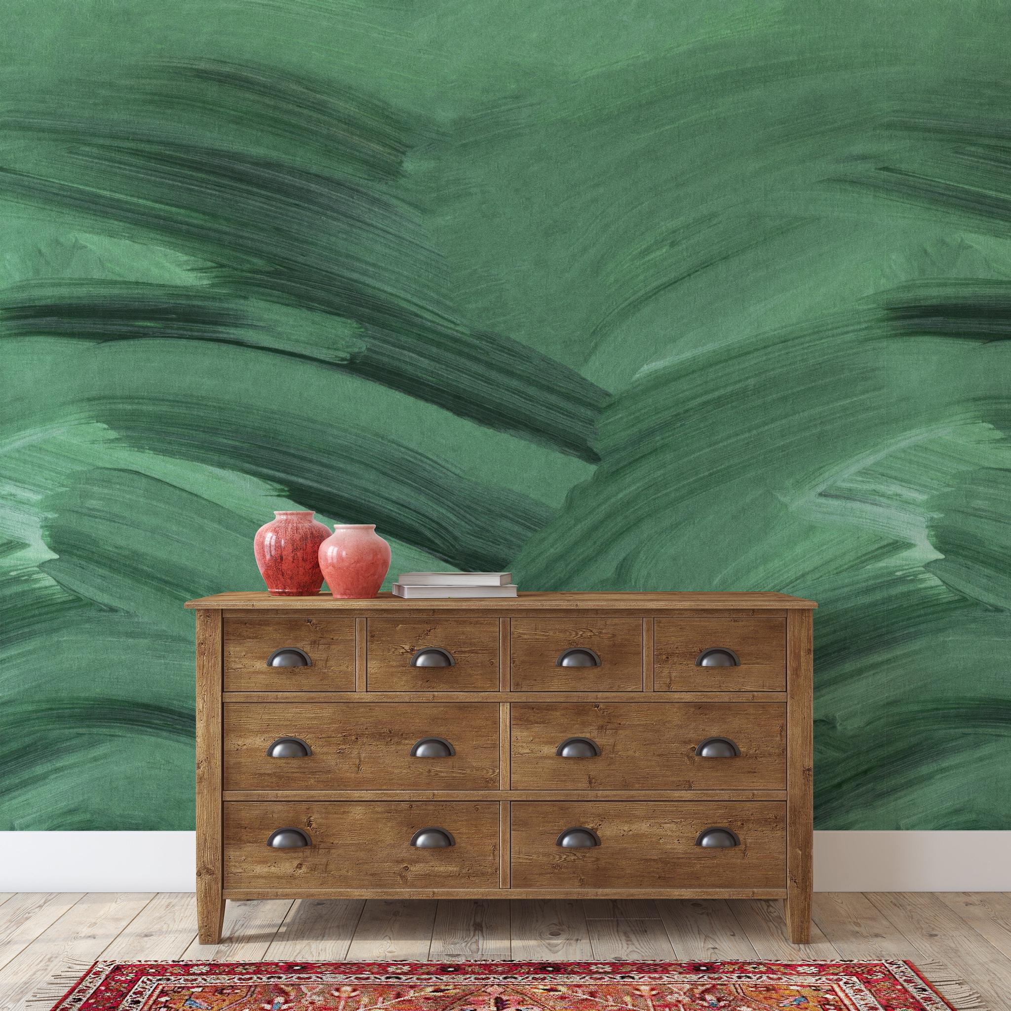 "Wall Blush Emerald Wallpaper featured in stylish living room with wooden dresser and decor accents."
