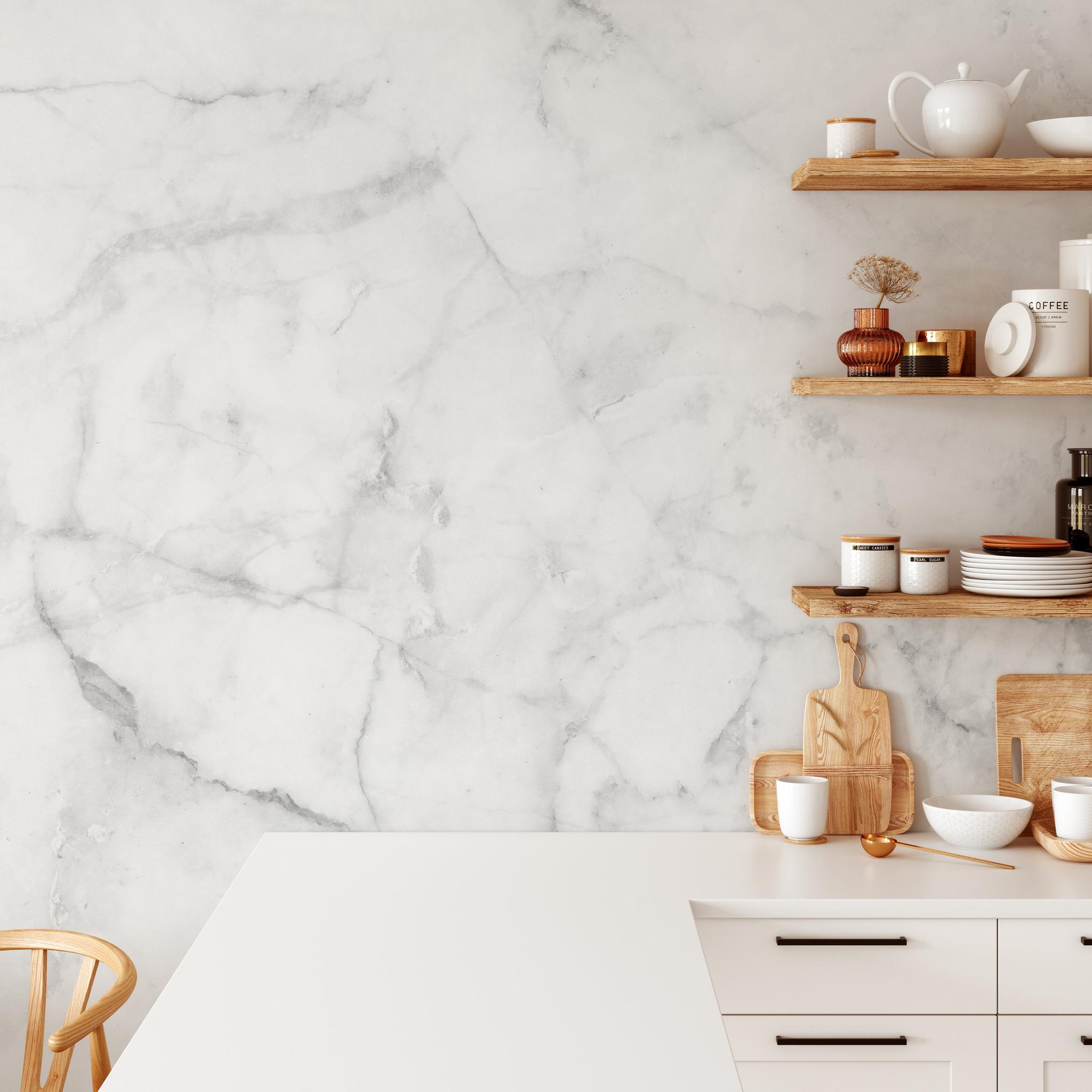 "Wall Blush Petra Wallpaper in a modern kitchen, featuring elegant marble design with open shelving and kitchenware."