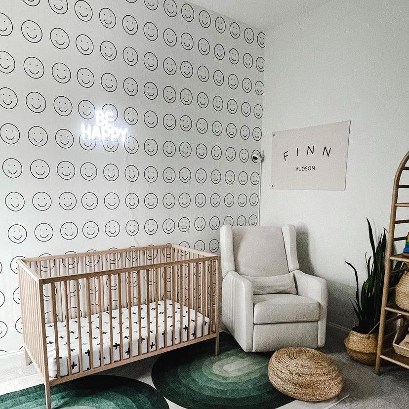 Be Happy Wallpaper by Wall Blush SG02 in a stylish nursery room focusing on the smiley pattern design.
