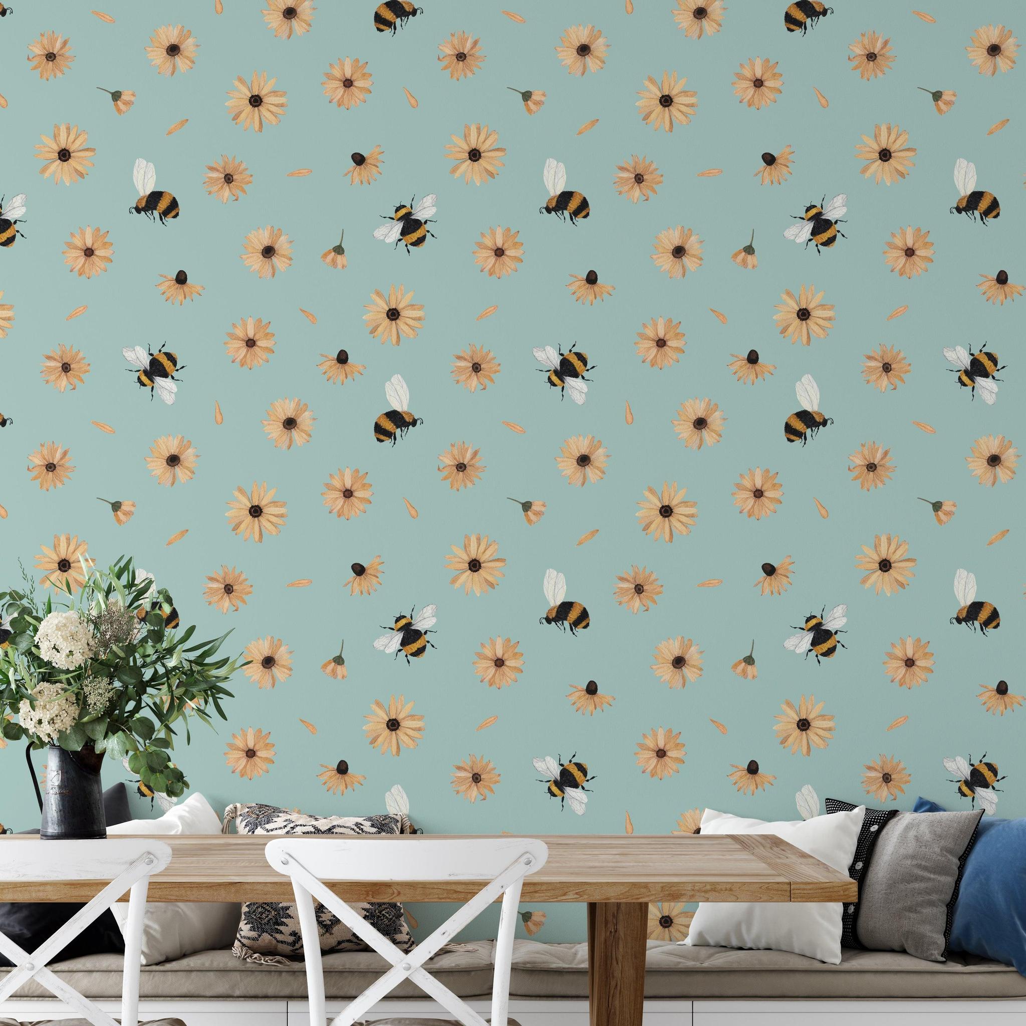 Bumble (Blue) Wallpaper by Wall Blush in cozy dining area, highlighting bee and daisy design focus.
