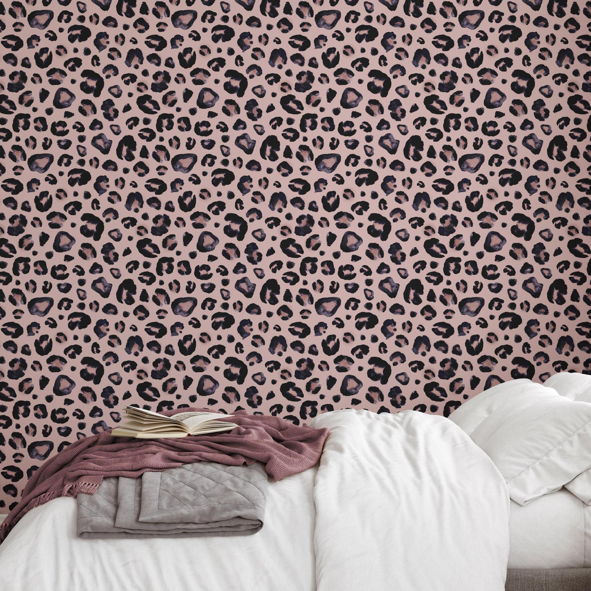 Cheetah Blush Wallpaper by Wall Blush in cozy bedroom setting, showcasing stylish pink animal print design.