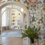 "Mia White Wallpaper by Wall Blush in a cozy reading nook, featuring elegant floral patterns as the focal point."