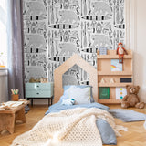 "Wall Blush 'Trail Blazer Wallpaper' in a cozy children's bedroom highlighting playful animal designs."