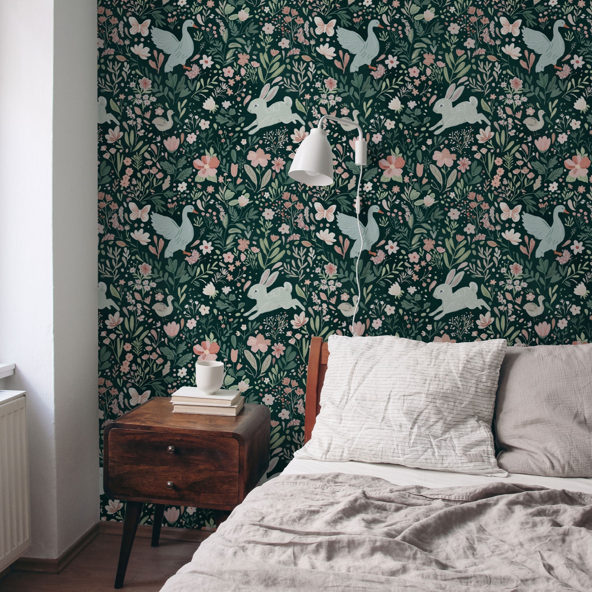"Wall Blush Wildwood Friends Wallpaper adorning a cozy bedroom, showcasing design focus in a home setting."