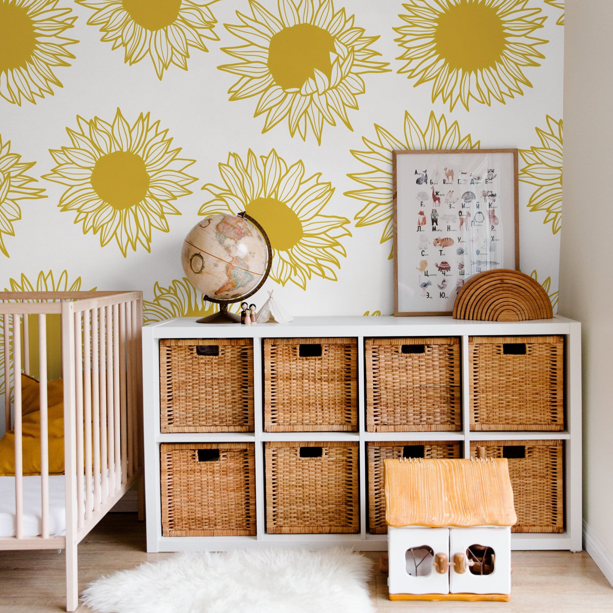 "Wall Blush's Penelope Wallpaper featuring large sunflower design in a cozy nursery room setting, highlighting wall decor."