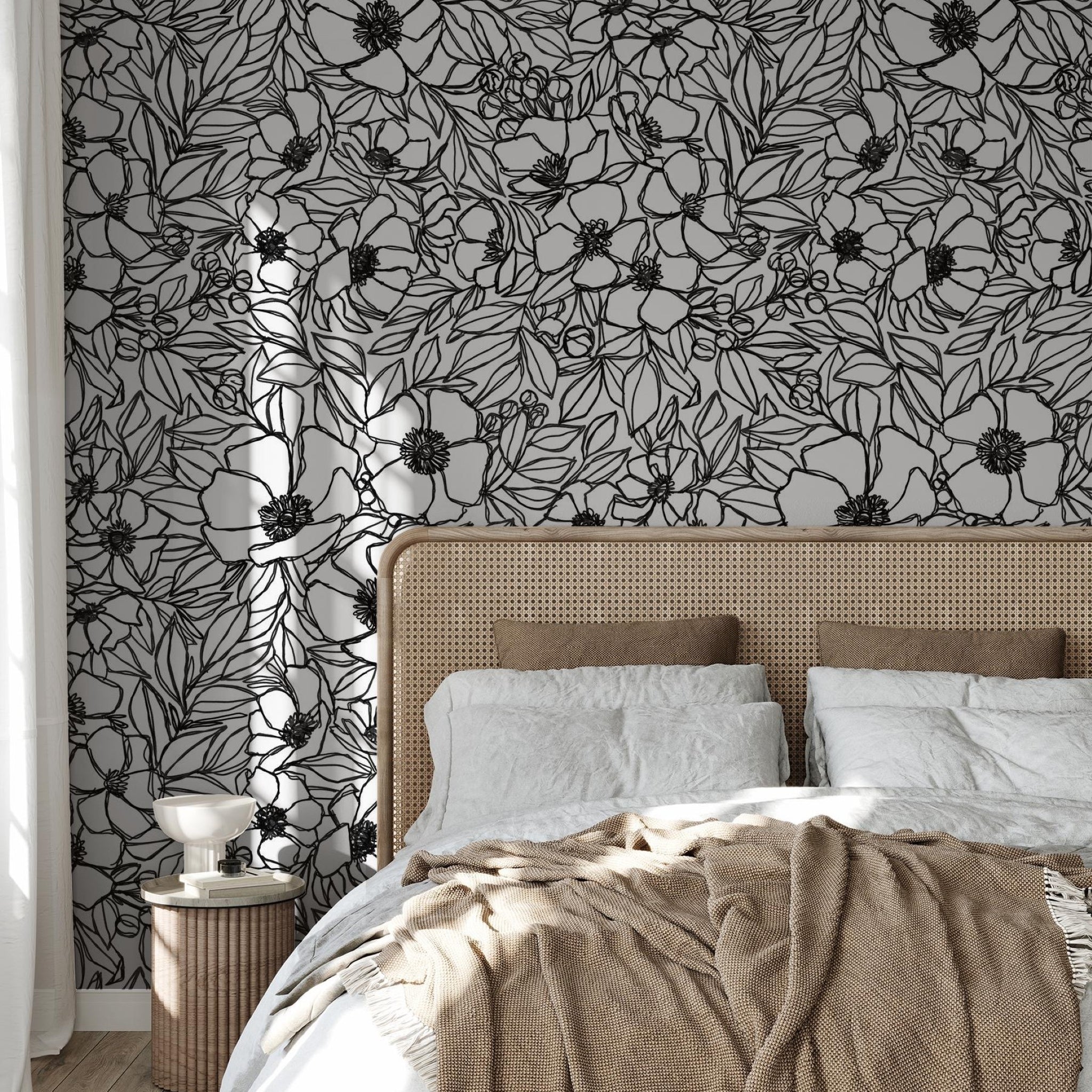 "Wall Blush's Inked Blossom Wallpaper accentuates the cozy bedroom, highlighting the elegant floral design."