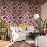 "Vibrant Azalea Wallpaper by Wall Blush decorating the living room wall with colorful floral patterns."