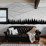 "Wall Blush's Sea to Summit Wallpaper featured in a cozy living room, highlighting the artistic mountain design."