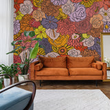 "Vibrant Juno Wallpaper by Wall Blush in a modern living room, highlighting bold floral design as the main feature."