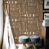 "Wall Blush Trail Blazer (Brown) Wallpaper in a cozy corner with rustic decor and knitted stools."